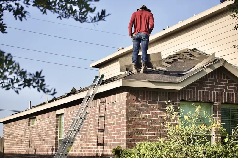 Professional roofer working on a residential roof in Machesney Park